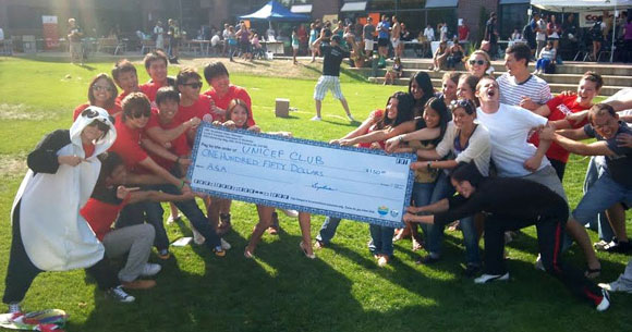 Members of the Asian Student Association (left) have donated $150 to the UNICEF Club on campus. The gift represented half of their $300 prize earned from a valiant second-place effort in the tug-o-war match during Clubs and Course Union Day Sept. 14. The UNICEF Club won the match, earning the top prize of $500.