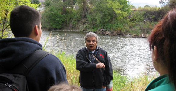 En’owkin Centre language instructor Richard Armstrong gives an informal orientation about the Okanagan Nation Alliance Salmon Feast on the banks of the Okanogan River.