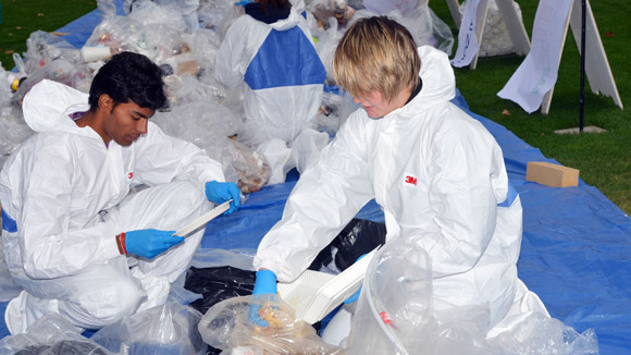 Omkrishna Shah, 2nd year management student, and Amanda Enevoldson, 2nd year biochemistry student help sort through trash at this year's waste audit.