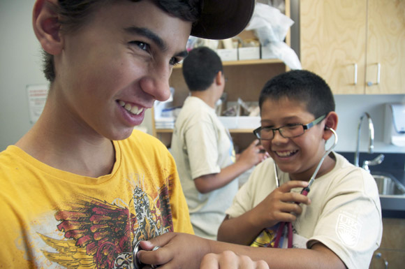 Okanagan high school students Ryan Price, left, and Brenden Wright try out their stethoscope skills during the nursing workshop at the Indigenous Summer Scholars Camp.
