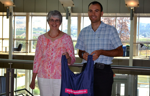 start an evolution Faculty and Staff lead volunteer Louise Nelson presents André Phillion, with his travel package prize.