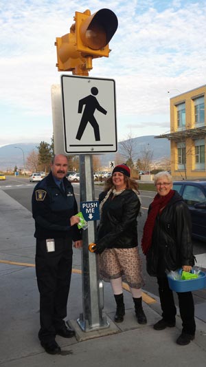 Security Coordinator Mike Gesi and graduate student Lynn Eileen show off pedestrian safety reflectors with ICBC Road Safety Coordinator Christine Silver.