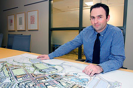 Anthony Haddad, Director, Okanagan Campus Planning and Development, with a concept drawing from the draft UBC Okanagan Master Plan. 