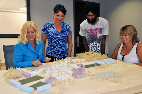 Members of the cake committee examine the model created for the campus master plan consultations last winter. The committee (from left): WRAP Coordinator Tracey Hawthorn, HR Advisor Tena McKenzie, engineering student Jannat Bachhal and WRAP Assistant Deb Oakley hopes to build a cake resembling the current campus.