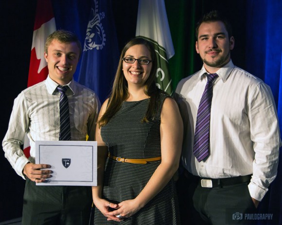 UBC civil engineering students Blake Cloutier (left) and Andre Prohoroff are presented with their second-place award by Amie Therrien, the Student and Young Professionals Program Coordinator, at the Canadian Society for Civil Engineering annual conference earlier this summer. 