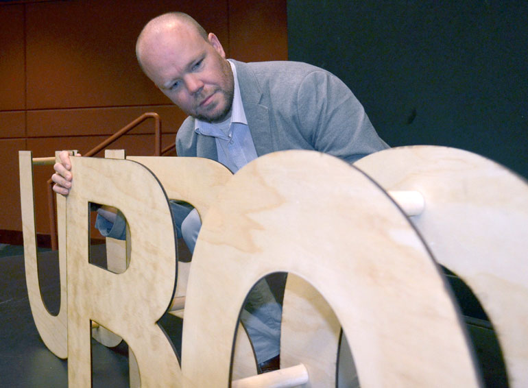 Commuter Student Coordinator Greg Mather lines up the ‘UBCO’ wooden blocks on stage in the University Theatre. Mather also acted as emcee for the second annual IAN Talks.