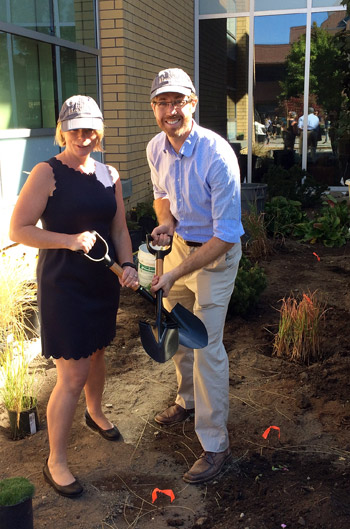 Shelley Kayfish, director of Campus Operations and Risk Management, and Derek Mahoney, manager of maintenance and grounds, break ground on the new xeriscape garden in front of the Engineering Management Education building. Photo credit: Kristin Forcier