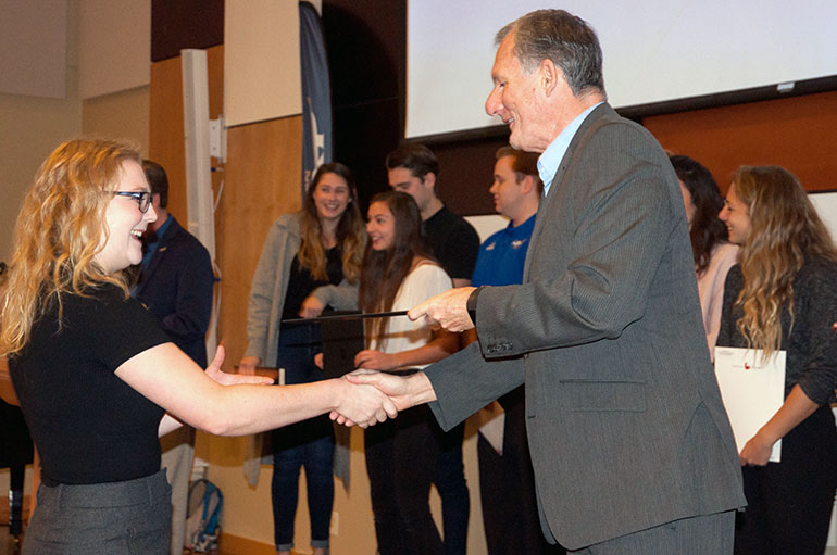 Human kinetics student Lindsey Berthelsen is congratulated by Associate Vice-President, Students Ian Cull at a special breakfast event last week.