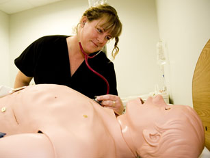 UBC Okanagan nursing student Liana Klohn listens to chest sounds produced by Stan, the School of Nursing's new Human Patient Simulator.