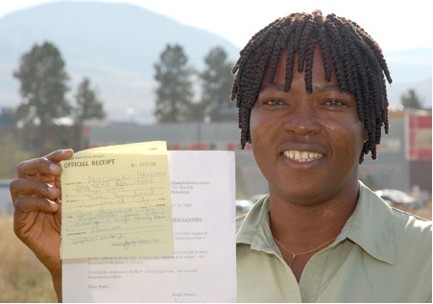 Vida Yakong, Master of Science in Nursing student, holds the receipt for registering a northern Ghana women’s group with the Red Cross. Registered groups can have foreign donations delivered across Ghana by the Red Cross at no cost.