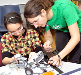 10-year-old Ocean Taylor from Bankhead Elementary School builds a Lego Mindstorm Robot with UBC student Monica Marton, who is in the first year of the Elementary Teacher Education Program.