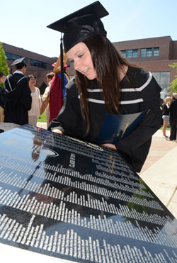 UBC graduate Shawna Hodgkinson looks at the 2010 plaque listing the names of all the graduates for that year. Plaques commemorating every grad class will be placed in walkways on campus.
