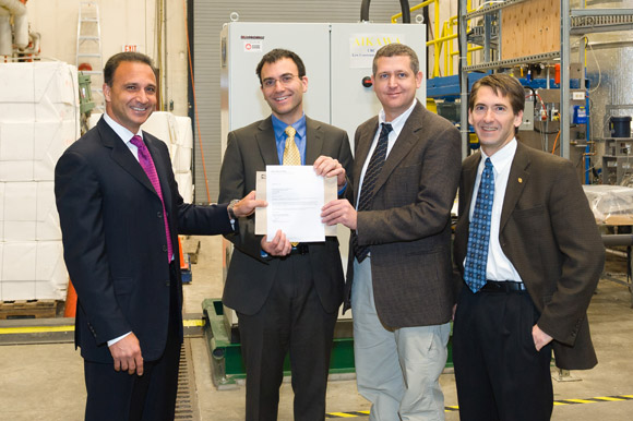 Joe Nemeth, president and CEO of Canfor Pulp Products Inc., presents a $75,000 grant award to  André Phillion, Mark Martinez, and James Olson, director of the Pulp and Paper Centre at UBC.
