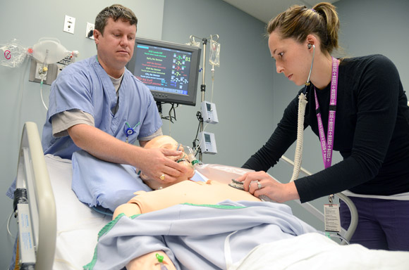 Registered nurse Lauren Garvie and respiratory therapist Bob Sommerville work on ‘Sam’ a high-tech patient simulator at the Pritchard Simulation Centre at Kelowna General Hospital Tuesday.