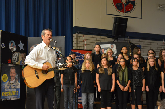 Col. Chris Hadfield plays the song, Is Somebody Singing, with students at École KLO Middle School.