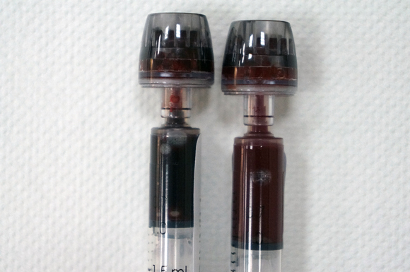 Vials contain samples (left) of blood at the end of a seven-minute breath-holding  experiment. The colour is dark, due to oxygen depletion. Vial on right shows test subject’s oxygen-rich blood prior to the experiment.