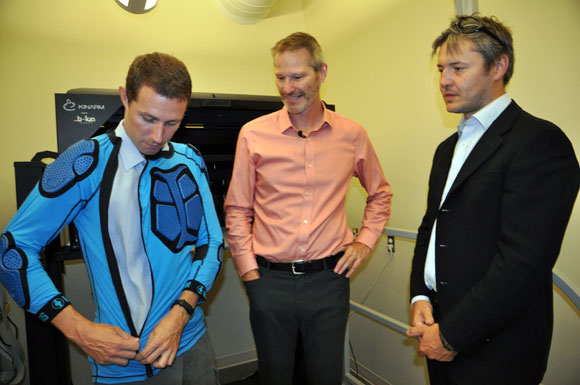 From left: PhD student Colin Wallace tries on a dirt biking shirt equipped with Armourgel protective covering, while UBC’s Paul van Donkelaar and Imperial College’s Dan Plant look on. Van Donkelaar, director of UBC’s School of Health and Exercise Sciences, studies concussions and is interested in Armourgel’s unique properties for use in sports helmets. 
