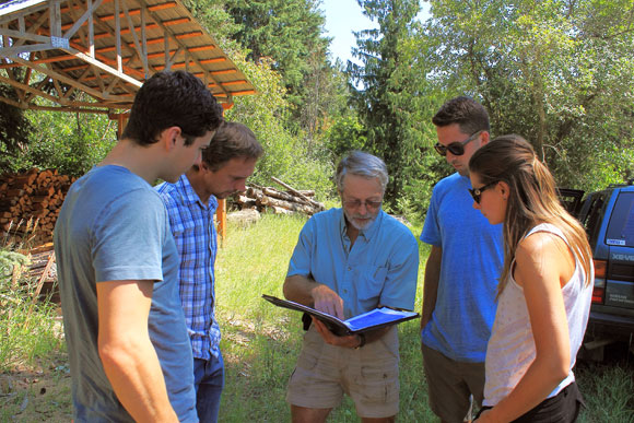 Using an aerial map of the Hulcar Valley north of Armstrong, BC, Steele Springs Water District chairman Brian Upper, centre, explains to UBC researchers Ted Wannop, John Janmaat, Quinn Rochon and Maryssa Soroke where the springs are located.