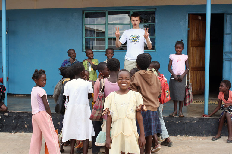 Tim Krupa plays with children orphaned by HIV and tuberculosis in the impoverished Chazanga compound in Lusaka, Zambia. Photo by Alexa Geddes 