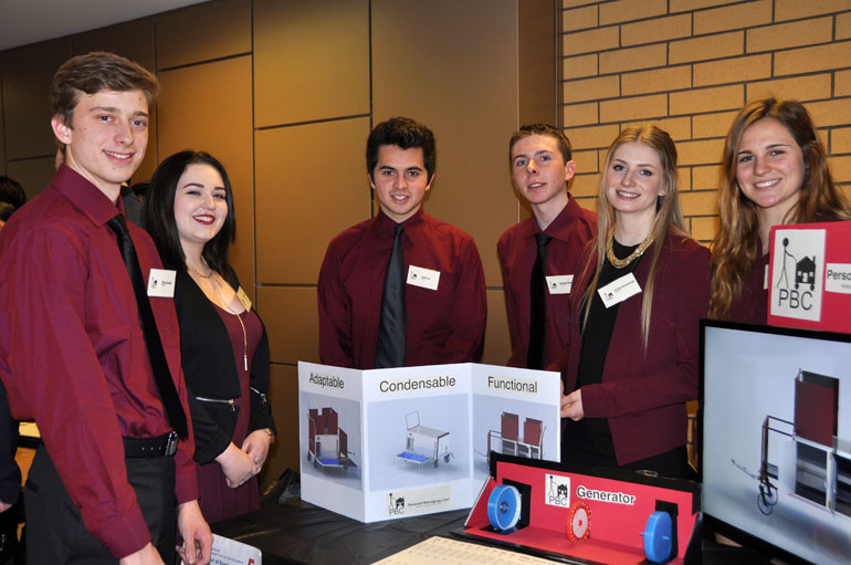First-year engineering students Ryan Kozak, Erin Kearney, Tyler Ho, George Muson, Emily Simmends, and Kaley Wainwright display their 'personal belongings cart' design during the recent Applied Science Design Showcase.