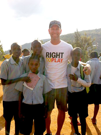 UBC Assist. Prof. Stephen Berg with school children in Rwanda.