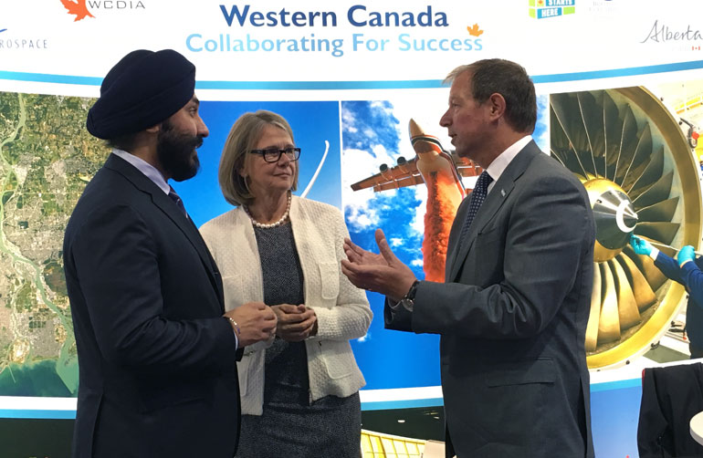 Avcorp CEO Peter George (right) discusses the new Learning Factory partnership with UBC Deputy Vice-Chancellor Deborah Buszard and Minister of Innovation, Science and Economic Development Navdeep Bains (left).