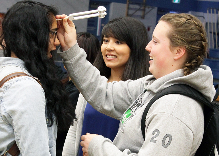 First-year UBC medical student Stephanie Schindler (middle) leads hands-on activity for students at LV Rogers Secondary in Nelson as part of the Healthcare Travelling Roadshow.
