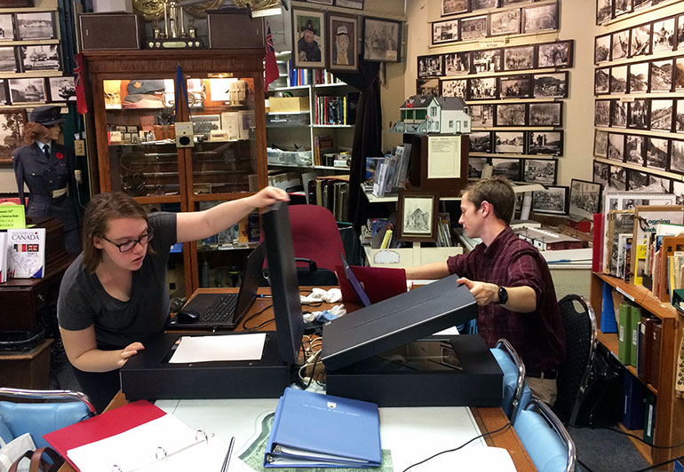 UBC students Emma Smith, left, and Eamon Riordan-Short scan historical material at Peachland’s museum as part of the Okanagan Region Historical Digitization Project.