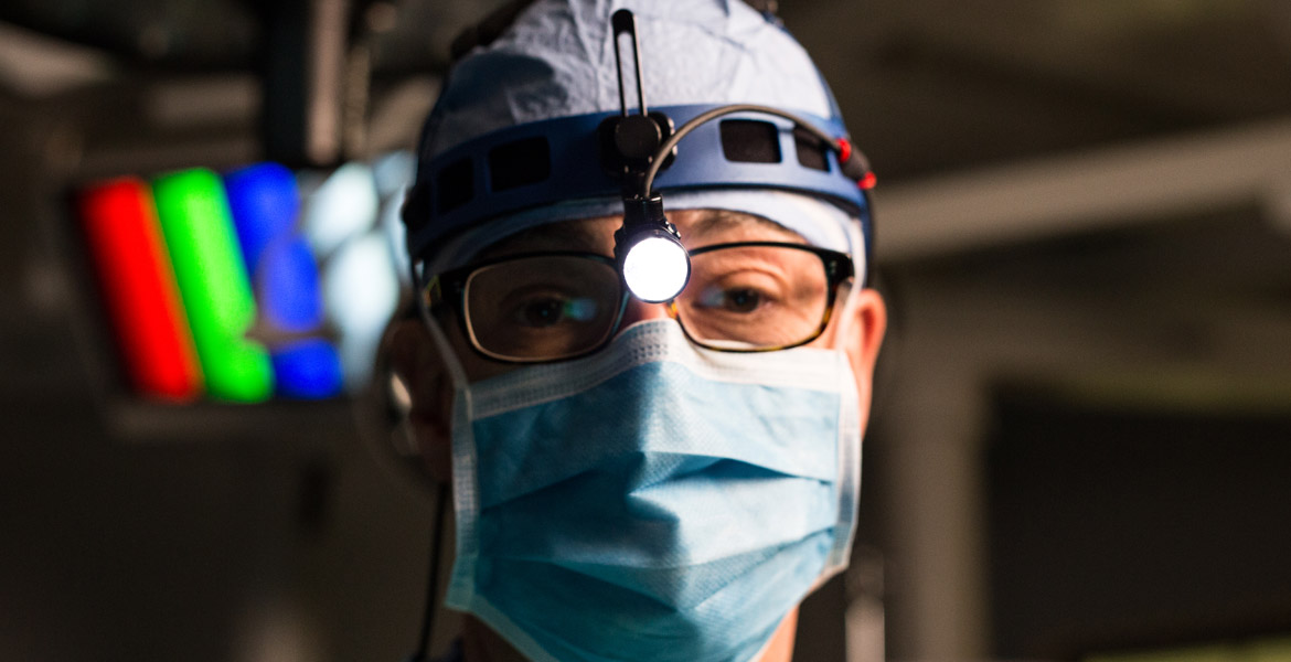 Surgeon wearing surgical headlight