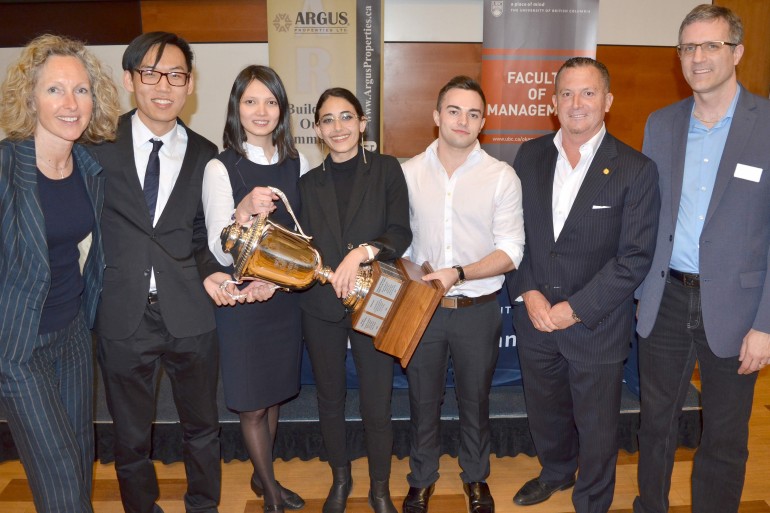 From left, lecturer Svan Lembke, David Gao, Stehaniya Mikhaylova, Marisa Matthews, Dan Thornton, Argus Properties President Ted Callahan and Faculty of Management Director Mike Chiasson celebrate with the Argus Cup after the 2018 Live Case Challenge.