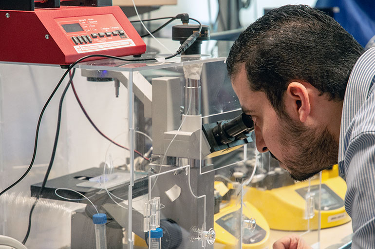 Doctoral student Mohamed Gamal uses a newly developed cell encapsulation device.