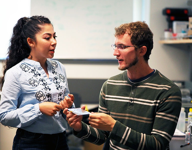 UBCO graduate students Kiana Mirshahidi and Ben Wiltshire demonstrate how small and portable the tiny ice detection senor is. The device has many ramifications, especially for the airline industry. 