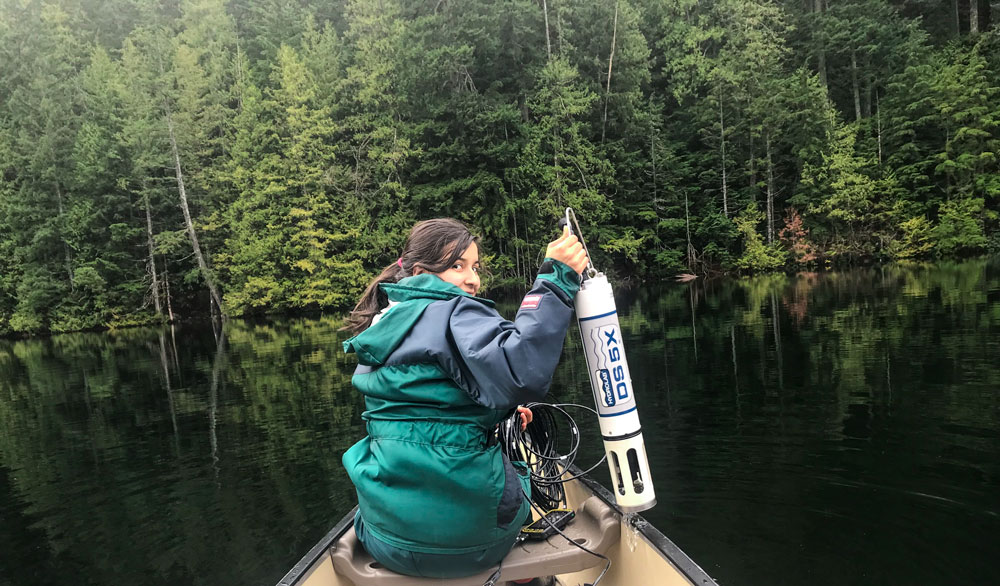 Co-op student student Melany Sanchez riding in boat, testing water samples on the BC's west coast