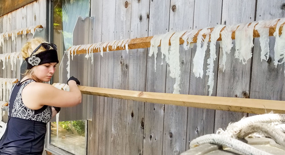 Alyssa Pembleton hangs fish to dry