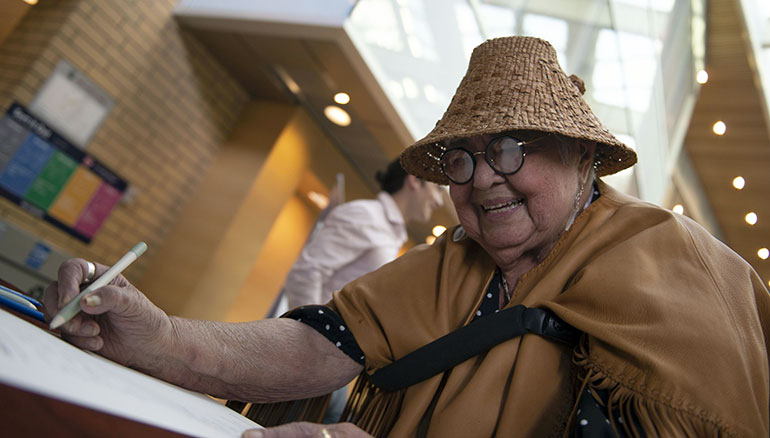 Shuswap Elder and UBCO Community Research Liaison Jessie Nyberg signs as a witness to the declaration of Truth and Reconciliation commitments at a special ceremony Tuesday.