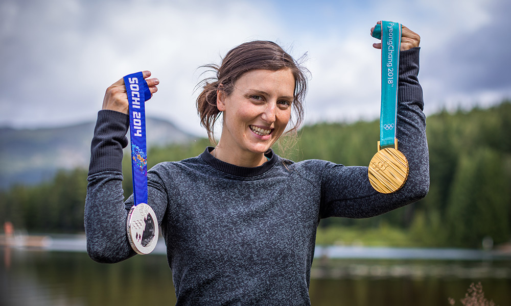 Olympic Champion Kelsey Serwa holding her gold and silver medals