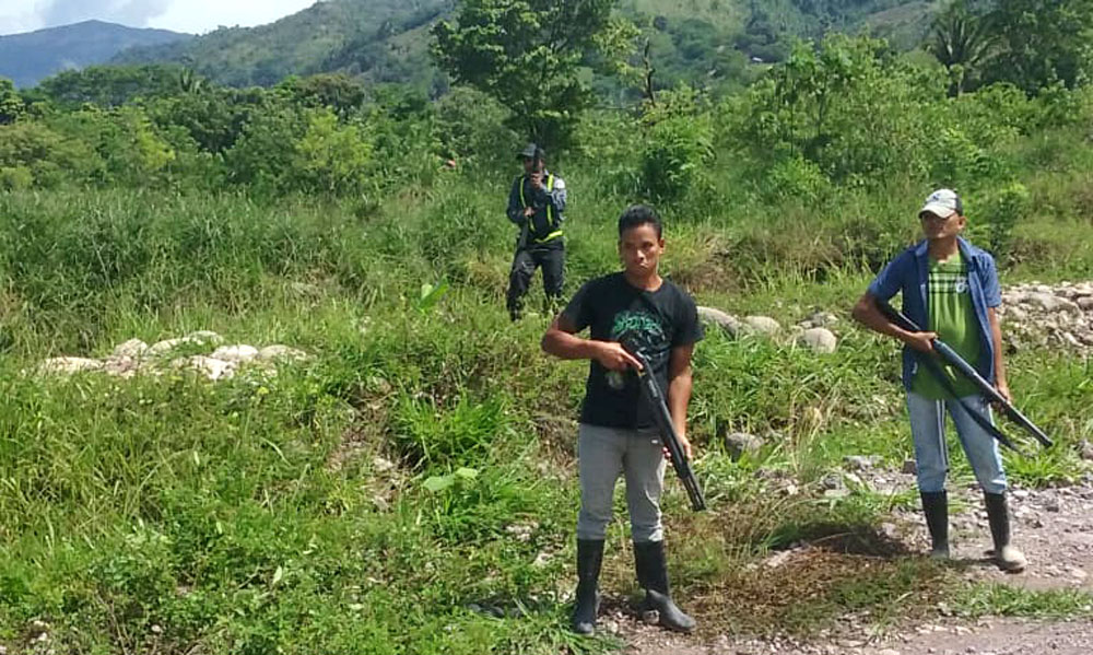 A paramilitary guards access to a local mine in Guapinol, Honduras