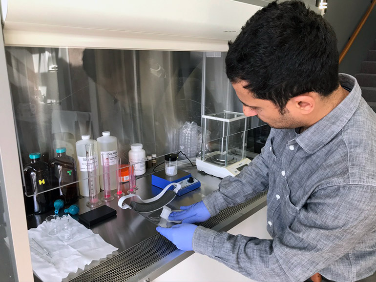 Chief Scientist at PRE Labs Mazeyar Parvinzadeh Gashti tests several different soap products on a protective face shield. 