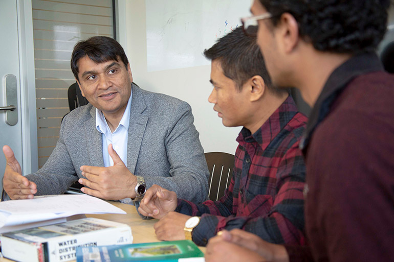 UBC Okanagan’s Rehan Sadiq, left, discusses drinking water assessment tools and benchmarking strategies with students Gyan K C Shrestha and Sarin Raj Pokhrel.