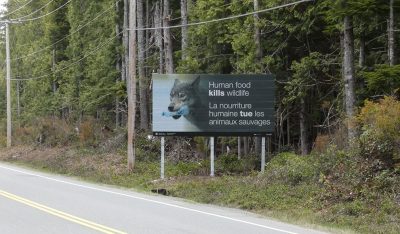 Sign saying "human food kills wolves"