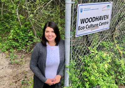 Rina Garcia Chua in front of Woodhaven sign