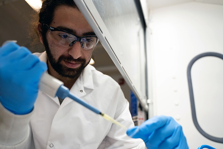 UBCO master's student Behrooz Khatir measures liquid to be applied to an omniphobic film during testing inside the OPERA lab at UBC Okanagan’s School of Engineering.