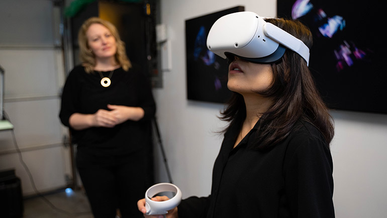 UBCO Associate Professor Megan Smith along with student Yugi Goa explore a virtual reality environment. 