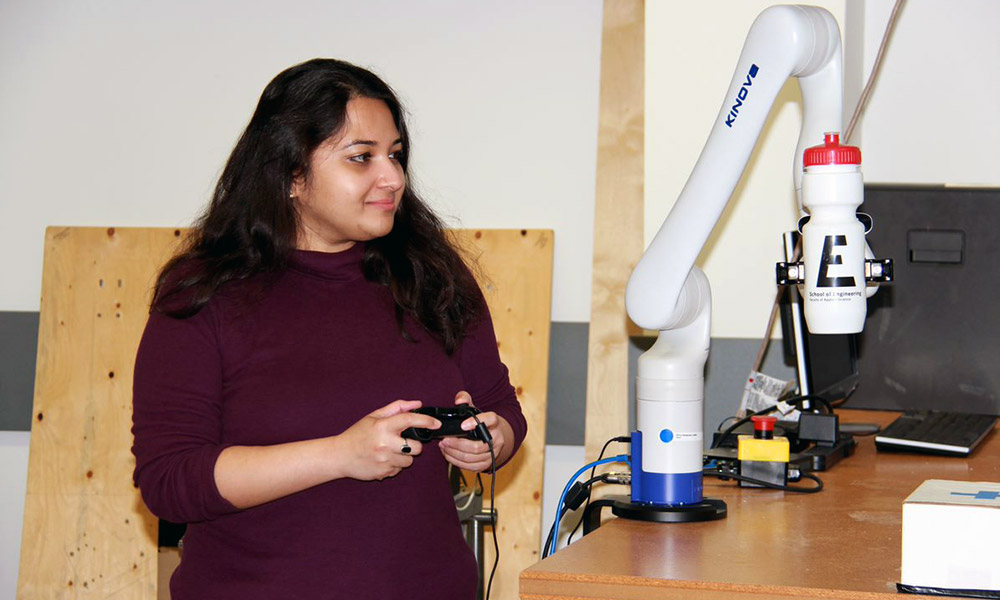 Female student working with a robot