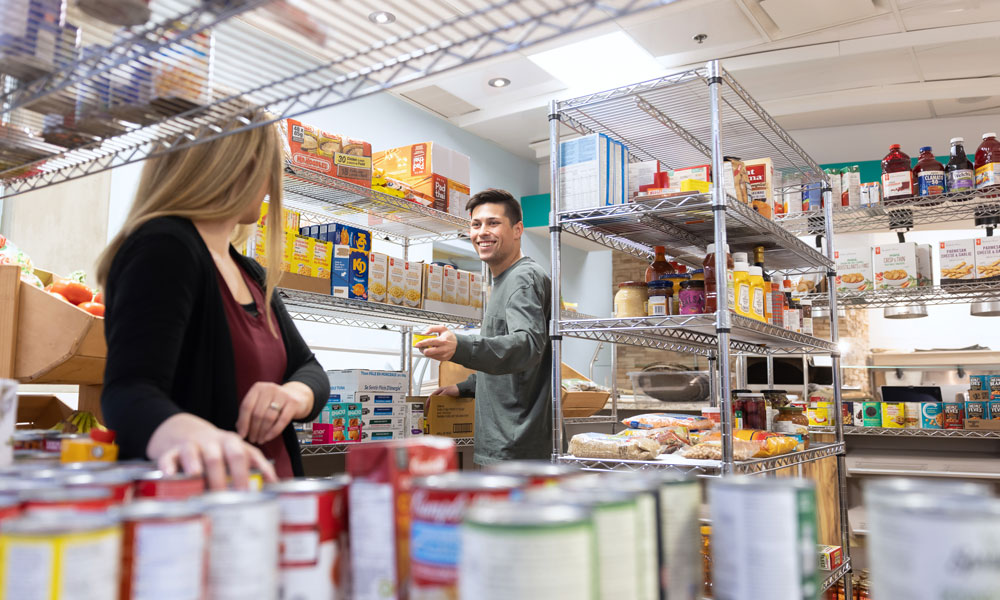 A man and woman looking at each other in a student food bank