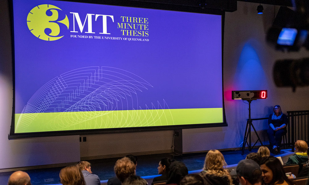 A photo of people gathered for a previous 3MT event