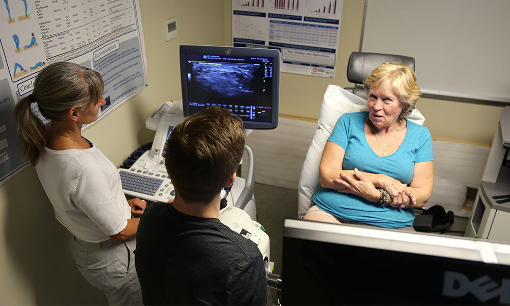 Dr. Jennifer Jakobi talking with a research patient