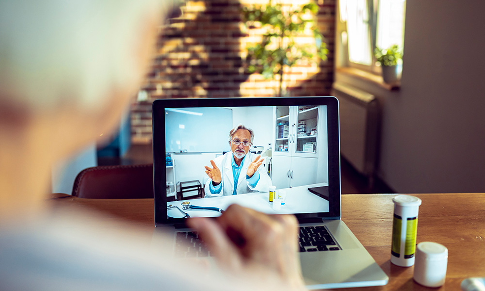 A photo of an elderly woman talking to a doctor using zoom