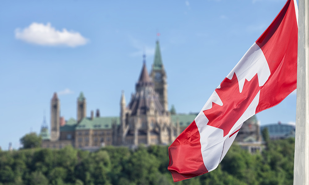 A photo of the Canadian flag looking over Ottawa