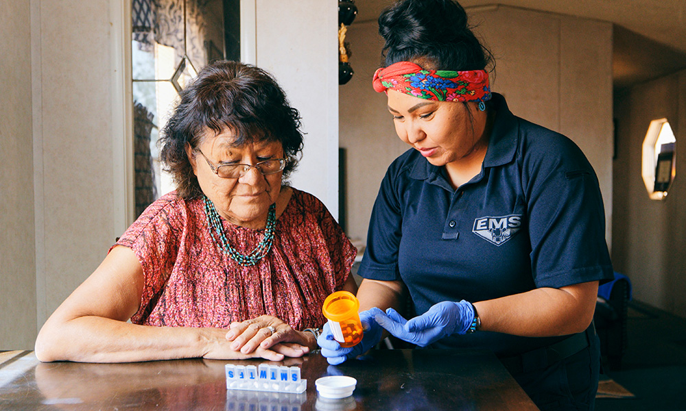 Healthcare Assistance in a home helping an Indigenous woman